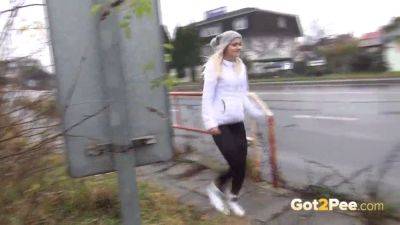 Amateur chick gets wet and wild at the bus stop with a shaved pussy and a public pissing session - sexu.com